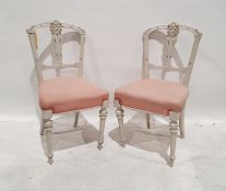 Pair of painted side chairs with pink upholstered seats, turned and fluted front legs to peg feet (