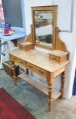 Early 20th century pine dressing table with rectangular mirror above two short drawers, the base