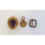 Victorian gold-coloured brooch, set with a mixed cut oval amethyst within a bead and greek key