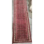 Large modern Eastern-style red ground runner with stepped border, 500cm x 91cm