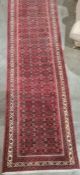 Large modern Eastern-style red ground runner with stepped border, 500cm x 91cm