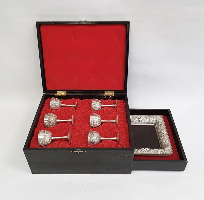 Cased set of six Oriental silver coloured metal goblets, with relief floral decoration, marked to