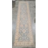 Modern Oriental-style duck egg blue ground runner with cream foliate decoration and cream ground