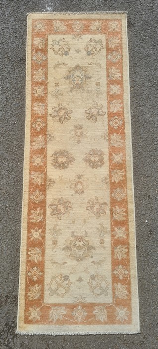 Cream ground runner with foliate decoration, peach ground border, 182cm x 62cm