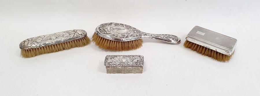 An Edward VII silver mounted dressing brush, floral decorated, Birmingham 1905, a silver mounted