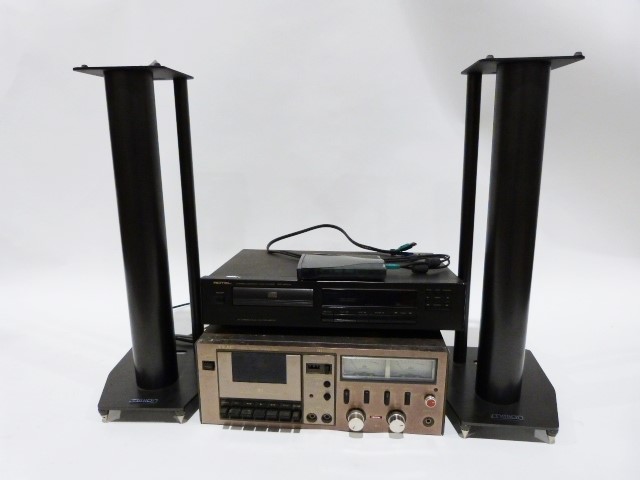 Rotel DVD player and a Teac stereo cassette deck and a pair of speaker stands