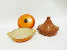 Le Creuset two-handled cast iron shallow dish and cover in orange enamel, 37cm wide over the handles