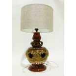 Pottery table lamp of baluster form with pierced and floral decoration in green and brown