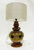 Pottery table lamp of baluster form with pierced and floral decoration in green and brown