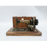Early 20th century German sewing machine by Frister & Rossmann with gilt painted decoration, the