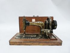 Early 20th century German sewing machine by Frister & Rossmann with gilt painted decoration, the