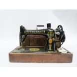 Singer sewing machine decorated with Egyptian style motifs, No. S7127435 in wooden case