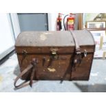 Vintage trunk with domed top and leather handles and straps, the locks bearing patent number and