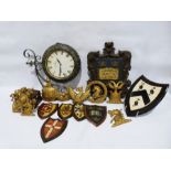 Double-sided vintage-style metal-framed clock, a carved wood armorial crest, assorted other gilt