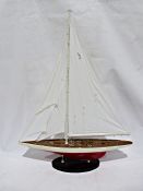 Modern pond yacht on a stand, single mast with rigging