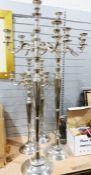 Silver coloured metal decorative floor standing candlelabra, two pairs, 142cm and 101cm (4)