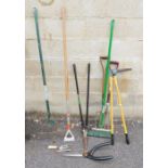 Assorted garden tools  to include a fork, garden rake, yard brush, garden shears, hoe etc.