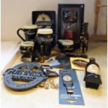 Collection of Guinness memorabilia to include boxed cups, socks and keyring, money box, teapot, a