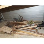 Large collection of garden tools to include four spades, pickaxe, etc