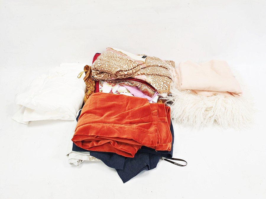 Quantity of textiles and clothing including a pair of orange velvet trousers, a paisley skirt, a