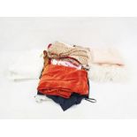 Quantity of textiles and clothing including a pair of orange velvet trousers, a paisley skirt, a