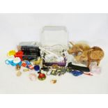 Box of various household items to include two wooden pig ornaments, a quartz radio, etc