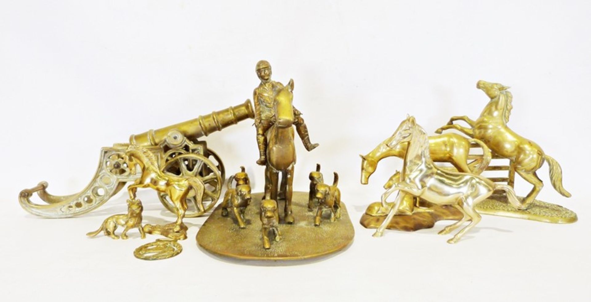 Two boxes of various brassware to include a cannon, various horse sculptures, horse and hounds, etc
