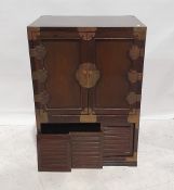 Two Chinese-style cabinets, one of three drawers above two cupboard doors with brass bindings and
