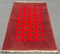 Modern Afghan rug, the central field with elephant foot guls on a red ground with multiple