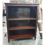 Open bookcase, the rectangular top with moulded edge, blind fretwork carved decoration, adjustable