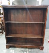 20th century mahogany open bookcase, the rectangular top with moulded edge, Greek key carving,