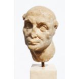 Marble bust of a man with tonsure hairstyle, possibly Roman (with losses), on square marble base,