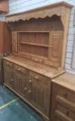 Modern pine dresser, the top with assorted shelves, drawers and cupboard doors, on base of three