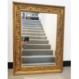 Rectangular mirror with bevel edged plate in moulded gilt-effect frame, 69.5cm x 96cm
