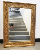 Rectangular mirror with bevel edged plate in moulded gilt-effect frame, 69.5cm x 96cm