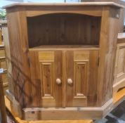 Pine corner low cabinet with open tier above two cupboard doors, on plinth base, 84cm high
