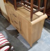 Modern oak-effect sideboard with three drawers, the central drawer flanked by cupboard door, on