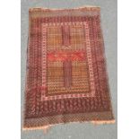 Rug, the central field with bands of decoration within multiple borders, in reds, blue and cream,