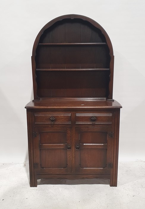 20th century oak Dutch-style dresser, the arched top above two shelves, the base with two drawers