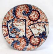 Large Japanese Imari charger with asymmetrical decoration including two panels of trees and birds,