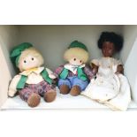 Two wind-up musical dolls with green hats and tartan outfits and an Armand Marseille black doll, the