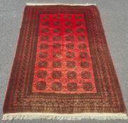 Modern Afghan rug, the central field with elephant foot guls on a red ground with multiple