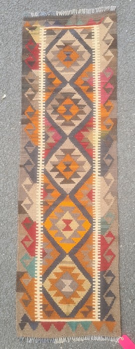 Maimana kilim runner with orange and blue lozenges on a brown ground, 203cm x 62cm