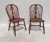 Set of eight 20th century elm seated wheelback chairs with crinoline stretchers, on turned