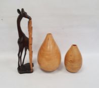 Two turned wooden vases and a hardwood model of a giraffe (3)