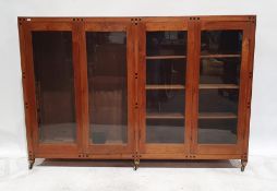 20th century mahogany inlaid bookcase with four glazed doors enclosing shelves, all raised on