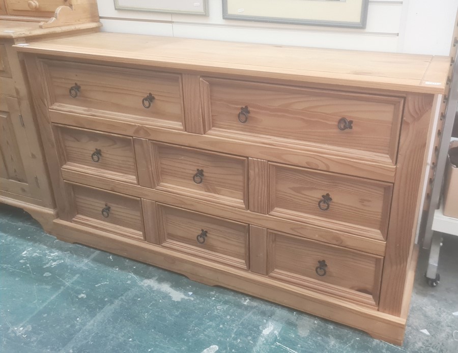 Modern pine chest of eight assorted drawers, on plinth base, 145cm x 82cm