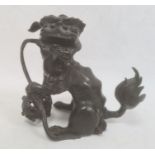 Chinese bronze model of a lion dog seated with pierced ball (with losses), 20cm high  Condition