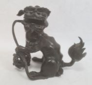 Chinese bronze model of a lion dog seated with pierced ball (with losses), 20cm high  Condition