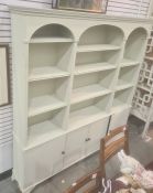 Painted dresser, the moulded cornice above three arches enclosing shelves, four cupboard doors